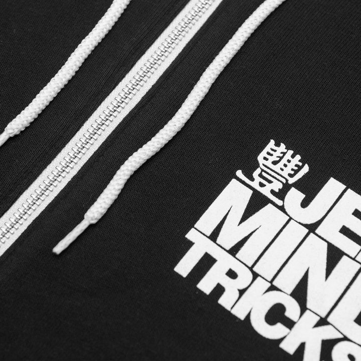 Close up of black zip hoodie with white drawstrings and design.